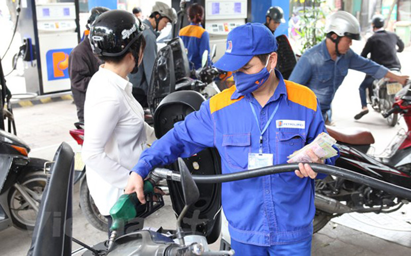 A fuel pump at a Vietnamese gas station showing new prices