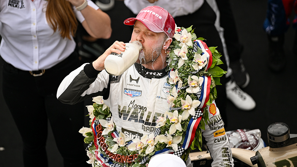 Felix Rosenqvist drinks milk in Victory Lane after winning the 2026 Indy 500